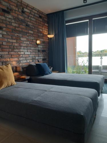 Posteľ alebo postele v izbe v ubytovaní Apartament nad Wilgą