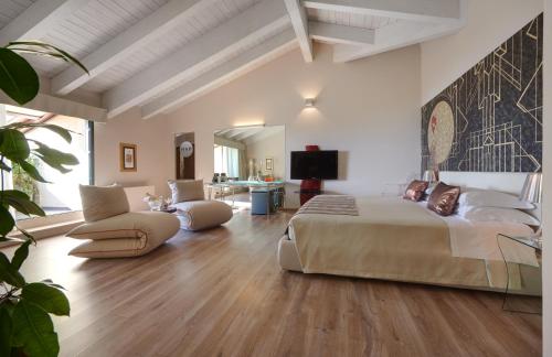 a bedroom with a large bed and a living room at Hotel Ristorante Sogno in San Felice del Benaco