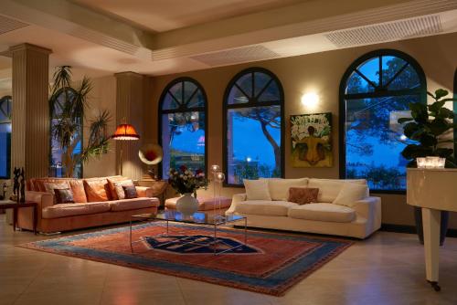 a living room with two couches and a rug at Hotel Ristorante Sogno in San Felice del Benaco