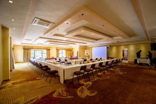 a large conference room with a long table and chairs at The Victoria Falls Deluxe Suites in Victoria Falls