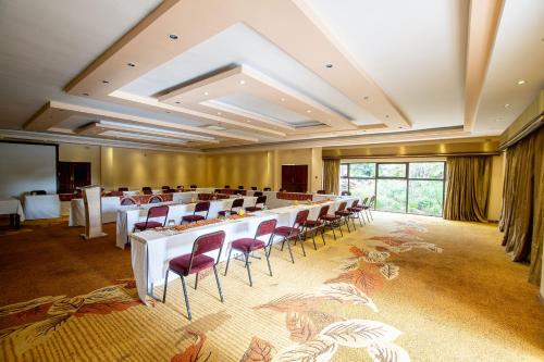 a large room with a long table and chairs at The Victoria Falls Deluxe Suites in Victoria Falls