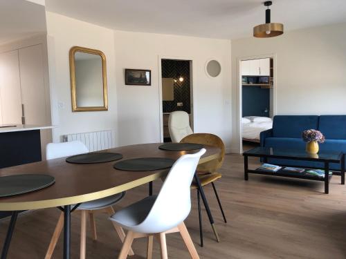 a kitchen and living room with a table and chairs at Vue mer exceptionnelle in Dinard