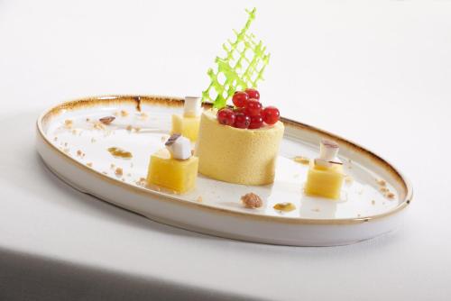 a plate with a dessert with fruit on it at Hotel Ristorante Sogno in San Felice del Benaco