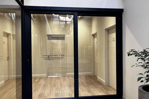 a sliding glass door in a room with a floor at Hermanus Waterfront Apartment No.20 in Hermanus