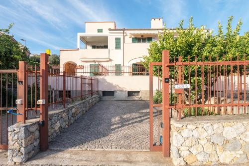 a gate in front of a house with a building at Babyaccommodation Family Garden in Borgio Verezzi