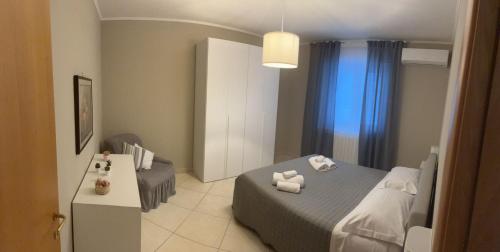 a bedroom with a bed and a table with towels at FAMILY HOUSE in Modugno