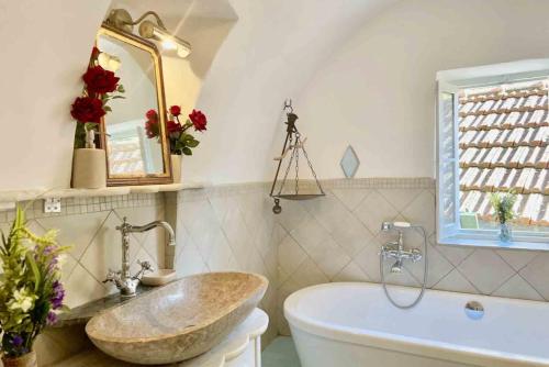 a bathroom with a large tub and a sink at Casa Celestine in Via Orsini Isolabona Liguria Italy Sleeps 5 in Isolabona