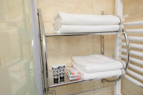 a towel rack in a bathroom with towels at Apartament Eliza in Poiana Brasov