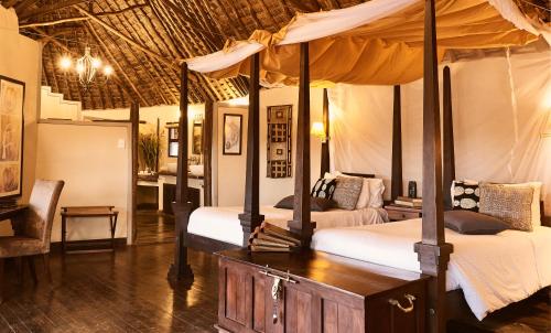 a bedroom with two beds in a room at Tawi Lodge in Amboseli