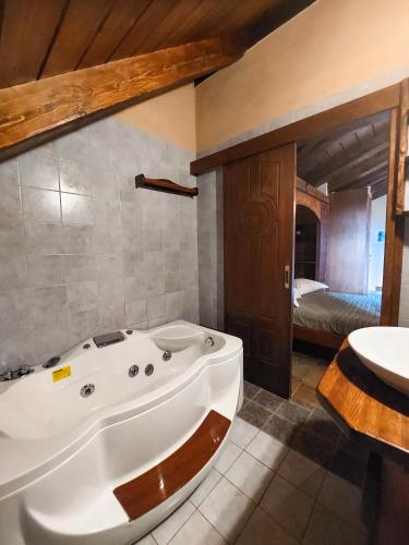 a large bathroom with a tub and a sink at Metohi in Marioláta