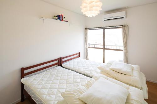 Katil atau katil-katil dalam bilik di Wave House 99 Beachside - Self Check-In Only