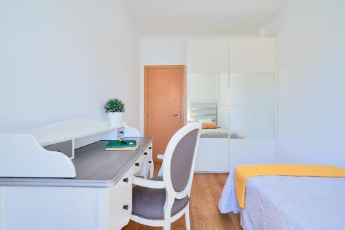a bedroom with a desk and a bed and a desk and chair at PENTHOUSE NEAR BEACH AND MALAGA TOWN also monthly hire and long term RENTAL CAR AVAILABLE in Málaga