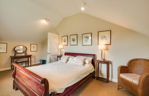 a bedroom with a bed and a chair at Belle Isle Castle and Cottages in Enniskillen