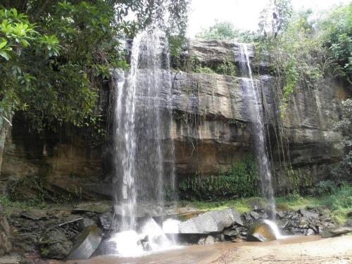 a waterfall in front of a rock wall at Villa PundaMilia Private Pool free wifi secure in Kwale
