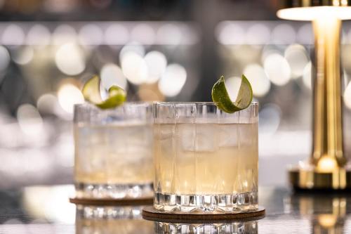 a group of glasses with a lime on a table at Sun Street Hotel Shoreditch in London