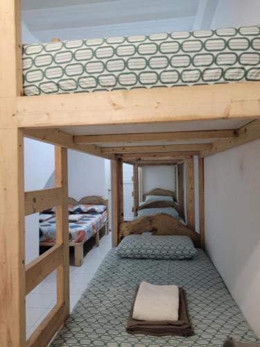 a bunk bed room with two bunk beds in it at Borj Place in Naga