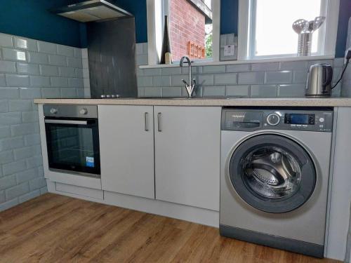 a kitchen with a washing machine and a sink at Inviting 1-Bed Apartment in Herne Bay in Herne Bay