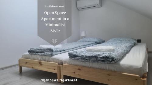 a bedroom with a bed with towels on it at Open Space Apartment in Belgrade