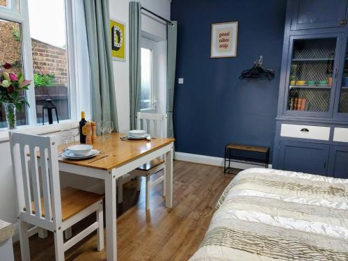a dining room with a table and a bed at Inviting 1-Bed Apartment in Herne Bay in Herne Bay