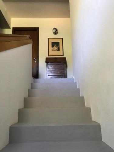 a stairway leading up to a room with a dresser at Bed&Breakfast La Madonnina in Marlia