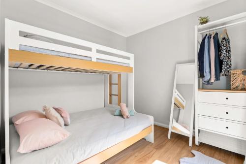 a bedroom with a bunk bed and a closet at Little Island Escape in Sunset Strip