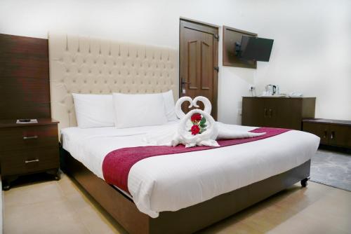 a bedroom with a bed with a stuffed animal on it at Jabal Al Akhdar Grand Hotel in Jabal Al Akhdar