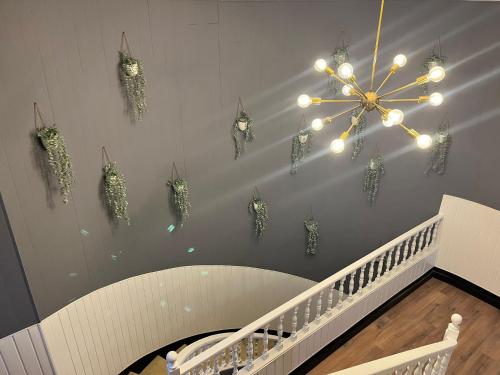 a chandelier with lights on a wall with a staircase at Alda Santa Trega in A Guarda