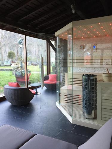 a glass room with two chairs and a table at A. Montesinho Turismo in Bragança
