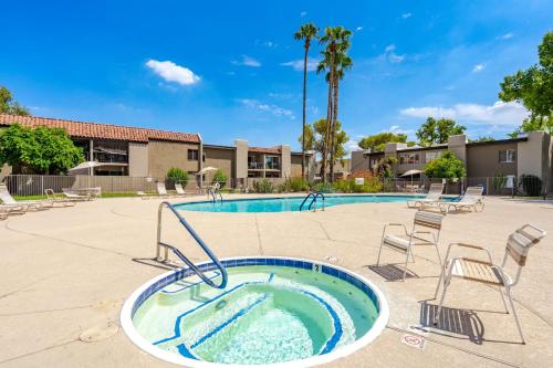 a swimming pool with chairs and a hot tub at Desert Paradise in Arcadia ~ Pool, Hot Tub, Views! in Phoenix