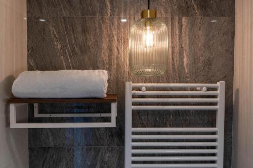a bathroom with a bench and a pendant light at Le Dimore del Centrale in Macerata