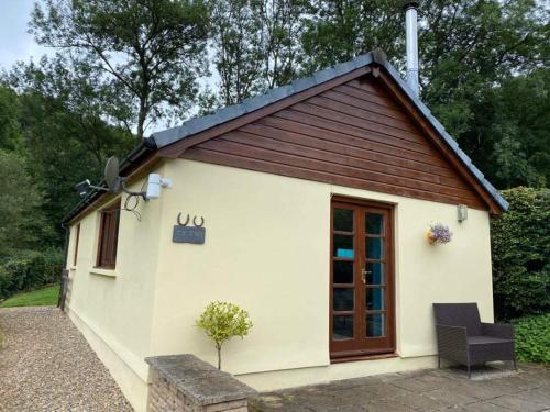 a small white building with a brown roof at Ty Twt - complete holiday home in Llandysul