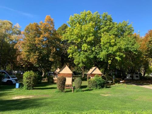 a park with trees and houses in the grass at AZUR Camping Regensburg in Regensburg