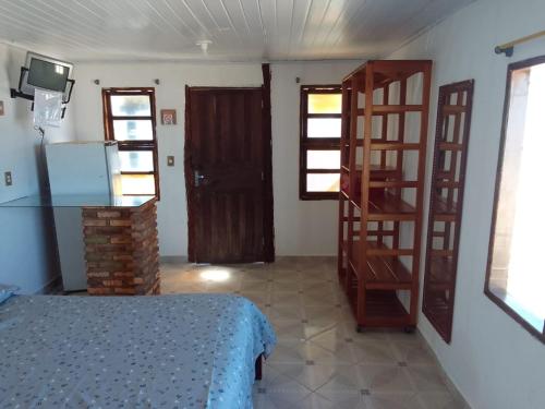 a room with a bed and a staircase in it at Pousada A Vila do Pirata in Prado