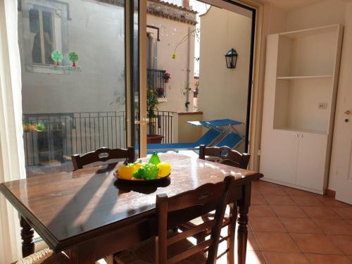 a dining room table with a bowl of fruit on it at Residence Degli Agrumi in Taormina