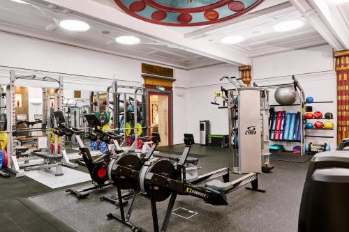a gym with several treadmills and machines at Andaz London Liverpool Street, By Hyatt in London