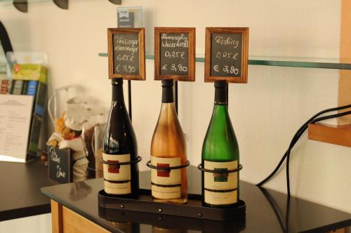 three bottles of wine sitting on a table at hogh Hotel Heilbronn in Heilbronn