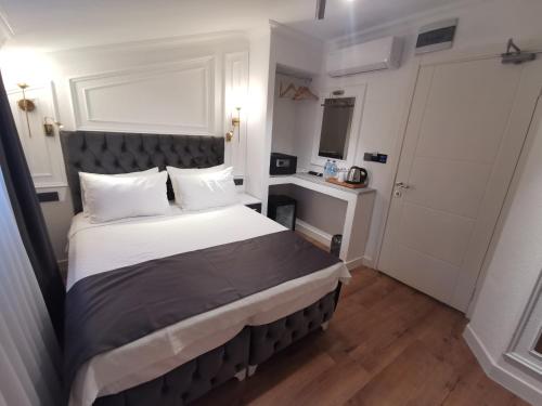 a bedroom with a large bed and a desk at Efzen hotel in Istanbul