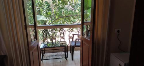 an open door with a table and a chair outside at Perola Marinha in Majorda