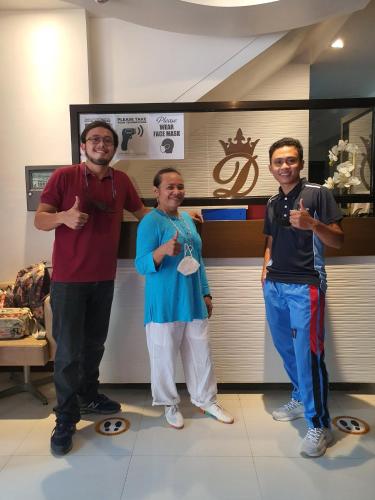 a group of three people standing in a room at Dianna’s Inn in Coron