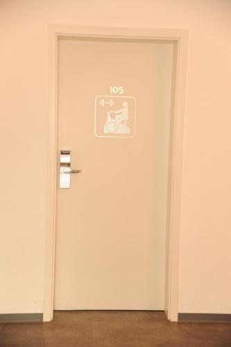 a white door with a sign on it at hogh Hotel Heilbronn in Heilbronn