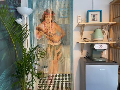 a shower curtain with a picture of a woman at Tropicana Guestroom 7 min walk from the beach in Dubai