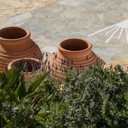 two large clay pots sitting on a patio at Kallisti Paros in Naousa