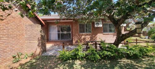 a house with a picnic table and a tree at Sea's the Day in St Lucia
