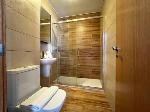 a bathroom with a toilet and a shower at Apartamentos Sierra Nevada 3000 in Sierra Nevada