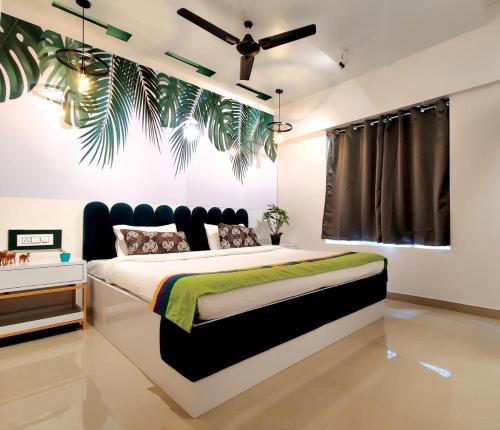 a bedroom with a bed and a ceiling fan at Horizon Apartment 1BHK in Pune