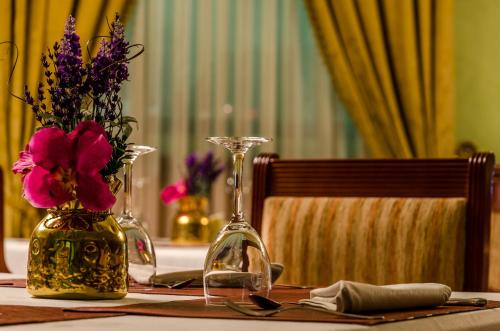 a table with two vases and flowers on it at Infanta Cristina in Jaén