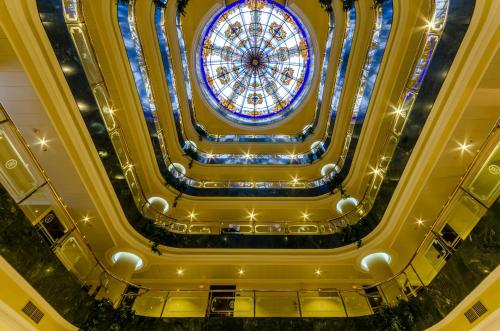 a ceiling view of a building with a stained glass window at Infanta Cristina in Jaén