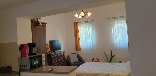 a bedroom with a bed and a desk with a tv at Cozy Home in the Heart of Cluj-Napoca in Cluj-Napoca