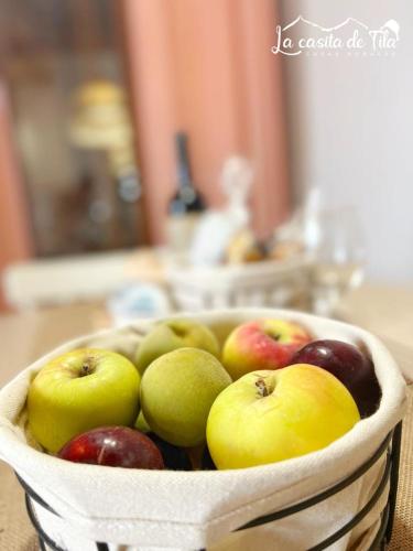 a basket of apples and pears on a table at La Casita de Tila in Ifonche