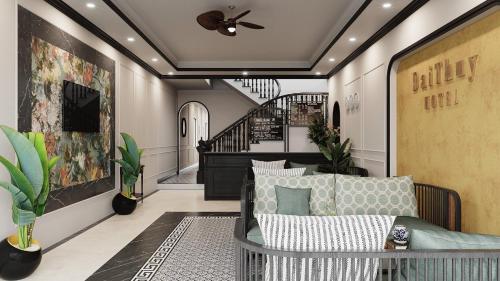 a living room with a ceiling fan and a staircase at ĐẠI THỦY Hotel in Cat Ba